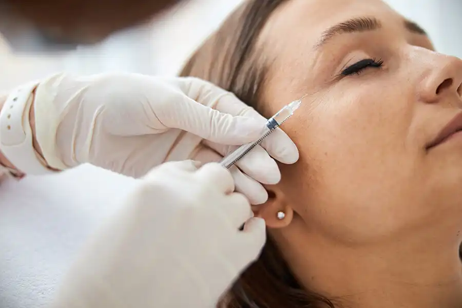Dr. Mehri Pourkand mapping facial injection points for Botox treatment in Jumeirah, Dubai.
