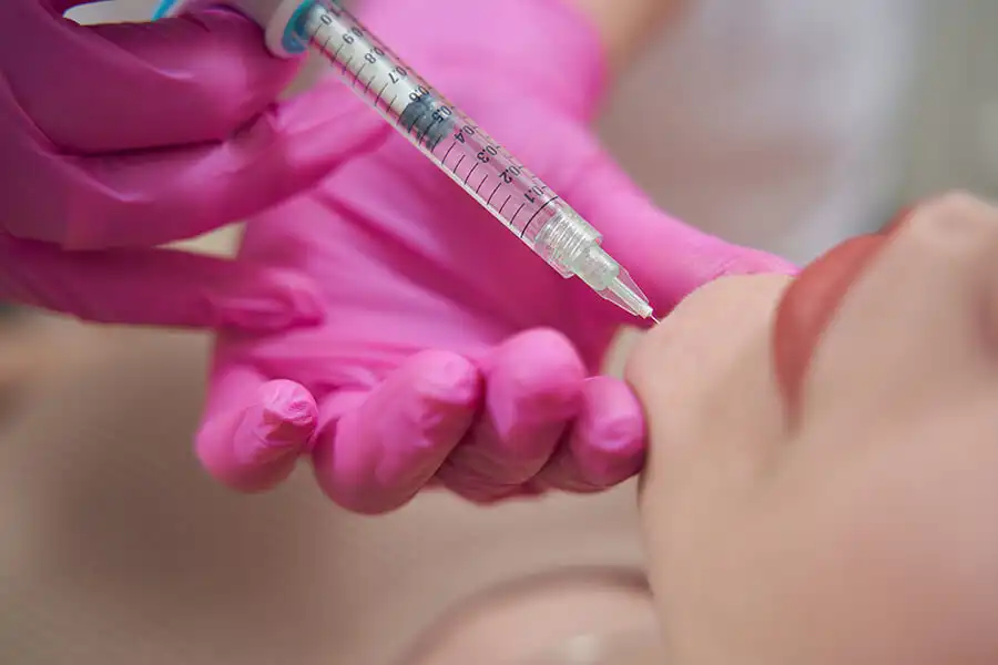 Administering Sculptra for facial volume restoration at Jumeirah aesthetic clinic.
